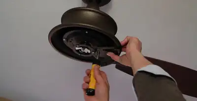 Electrician installing ceiling fan mounting bracket and fixture in Santa Rosa, CA