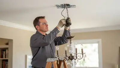 Electrician wiring a chandelier on a fixture-rated brace in a Santa Rosa, CA home
