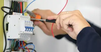 Electrician installing and adjusting circuit breakers in an electrical panel in Santa Rosa, CA