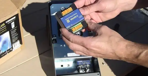 Electrician installing whole home surge protection unit inside main electrical panel in Santa Rosa, CA