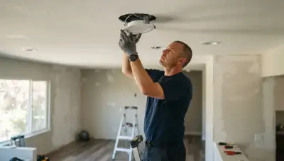 Electrician securing recessed light trim with spring clips in a Santa Rosa, CA ceiling