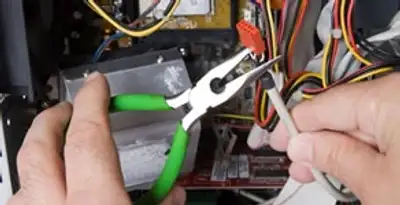 Licensed electrical contractor performing electrical repair with tools in Windsor, CA