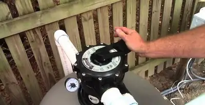 pool pumps service showing professional adjustment of pool pump control system in Santa Rosa, CA