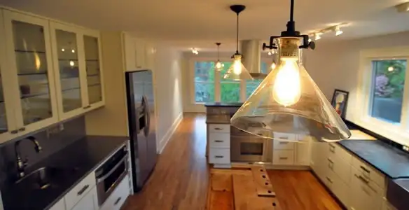 Residential electrician installing modern indoor light fixture in a home in Santa Rosa, CA