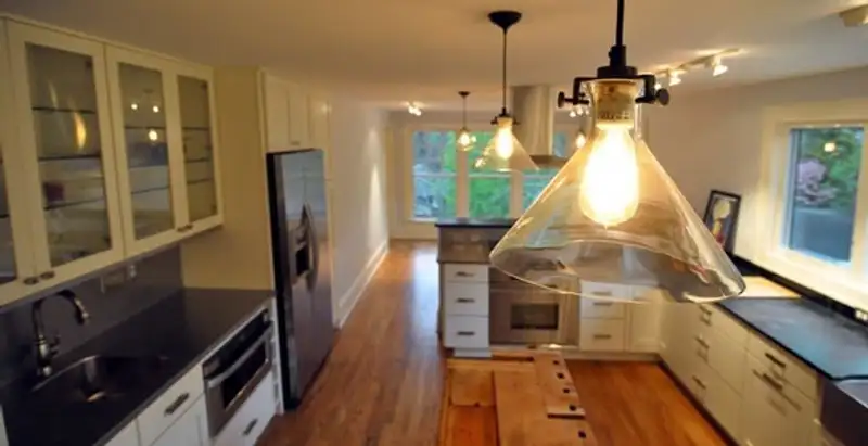 Residential electrician installing modern indoor light fixture in a home in Santa Rosa, CA