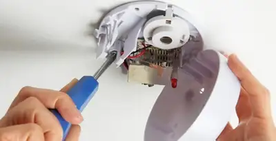 Certified technician wiring smoke detector during installation in Santa Rosa, CA
